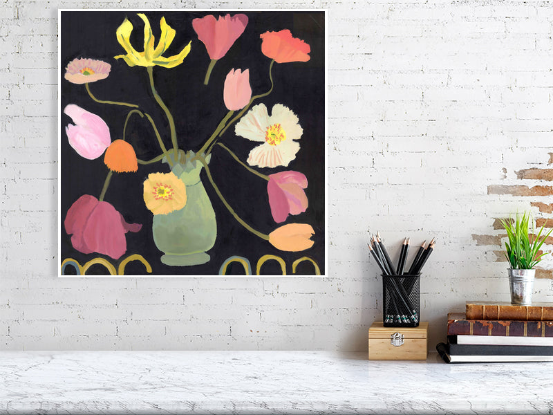 Large Giclée flower print of tulips and poppies in a green vase, styled on a white brick wall with books and desk accessories.