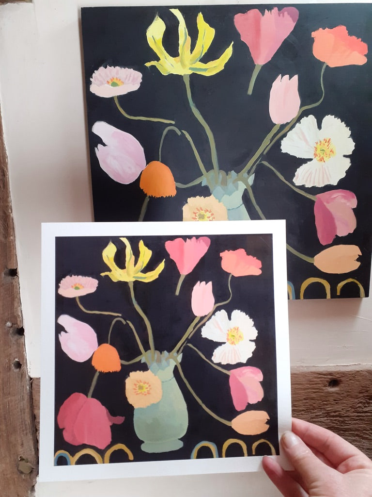 Comparison of two Giclée flower prints featuring tulips and poppies, one framed and one unframed, held against a rustic background.