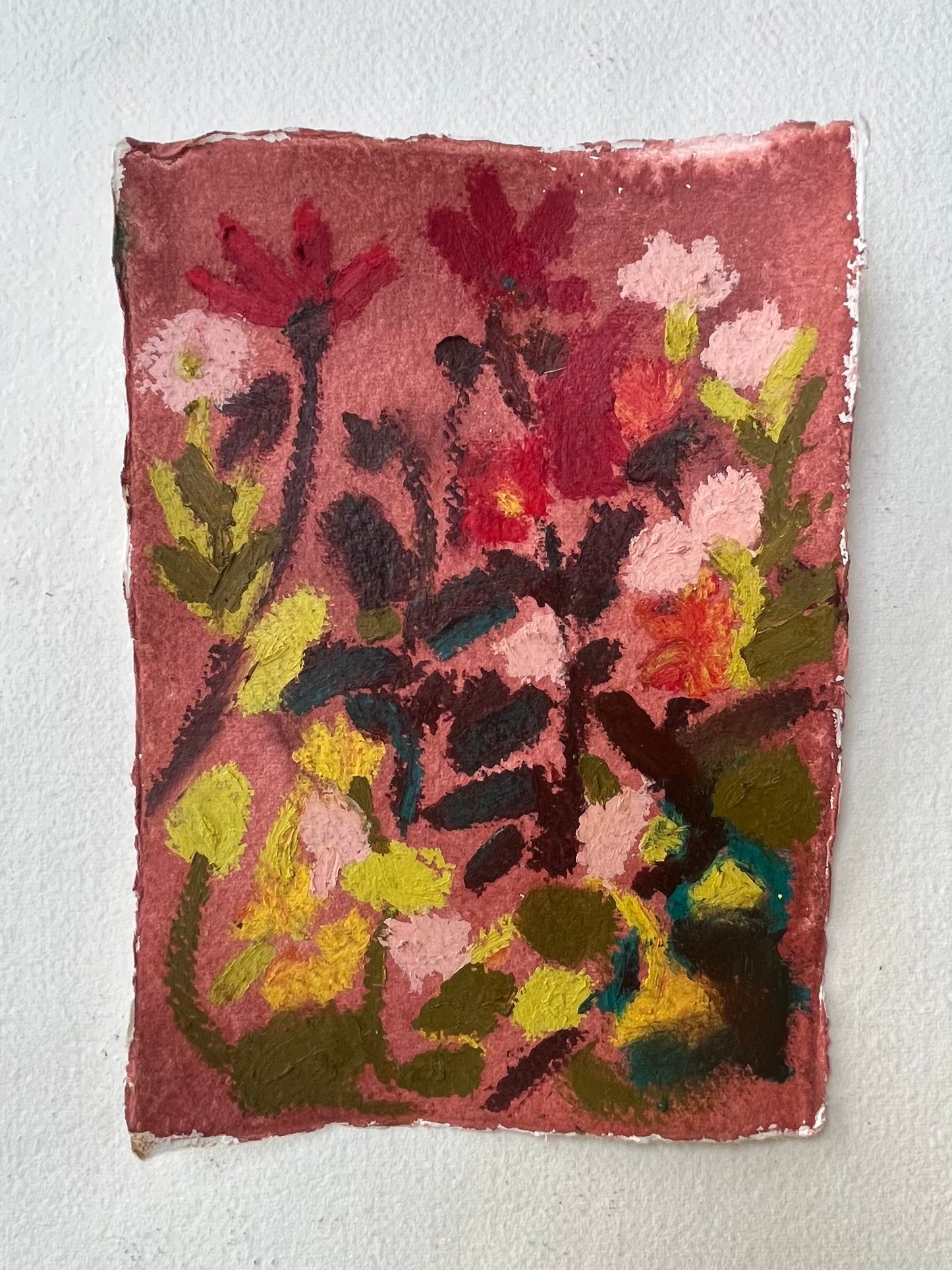 Oil pastel garden drawing featuring vibrant flowers in shades of pink, red, yellow, and green on textured paper.