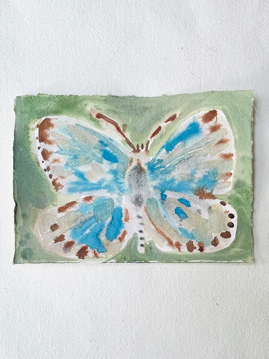 Butterfly No 7, a watercolor painting on paper featuring a blue and brown butterfly on a green background.