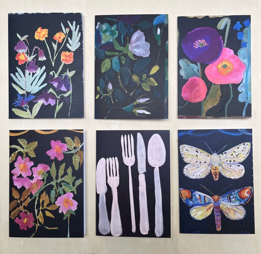 Box of 6 fine art greetings cards featuring floral and nature designs in vibrant colors on a dark background.